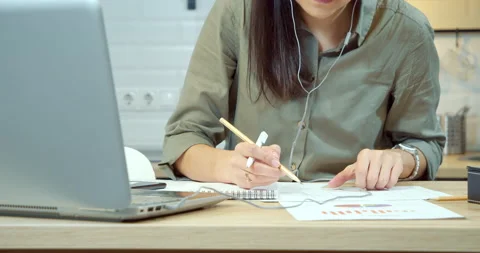 Young woman checking a project drawing writing down data in a notebook Stock Footage 131993935