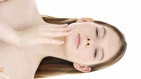 Young woman is checking state of her skin, making facial massage. Stock Footage 175456926