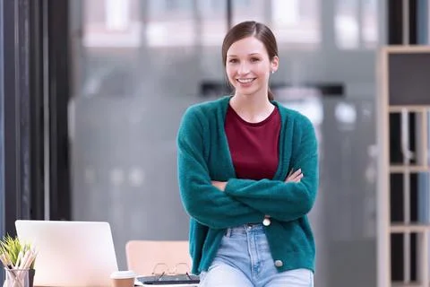 A young woman cheerful standing In the office room. Stock Photos