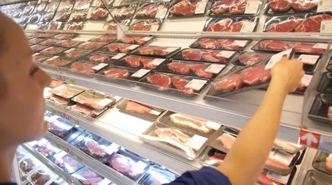 Young Woman Choosing Meat in Supermarket Stock Footage