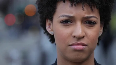 Young woman in city face portrait serious Stock Footage