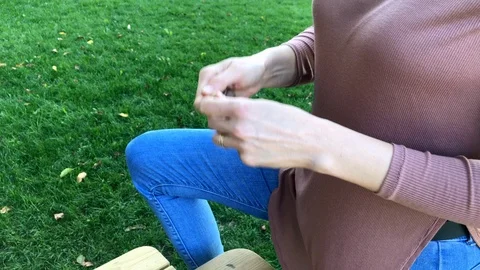 Young woman cleans walnuts from kernel and eat them. Stock Footage 116611663