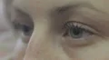 young woman closes and opens her beautiful blue eyes - macro HD Footage