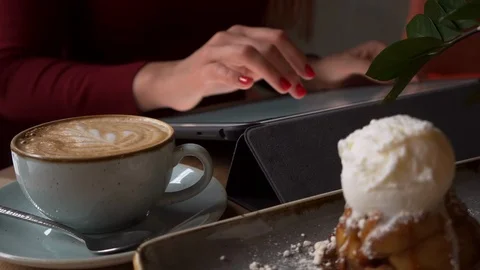 Young Woman Closeup Using iPad Pro in Cafe 4K. Female hands typing on Tablet. Stock Footage 112396194