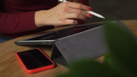 Young Woman Closeup Using iPad Pro in Cafe 4K. Female hands drawing on Tablet. Stock Footage 112396390