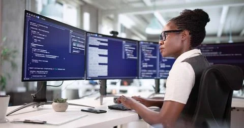 Young Woman Coding On Computer Screen As Web Developer In Office. Stockfoto's