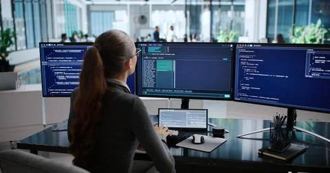 Young Woman Coding On Laptop, Working Remotely In Cloud Environment. Stock Photos
