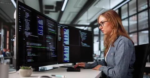 Young Woman Coding On Office Computer As Software Programmer Engineer. Stockfoto's