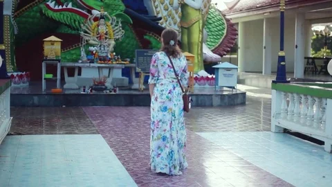 Young woman coming in temple complex Wat Plai Laem on Koh Samui, 1920x1080 Stock Footage