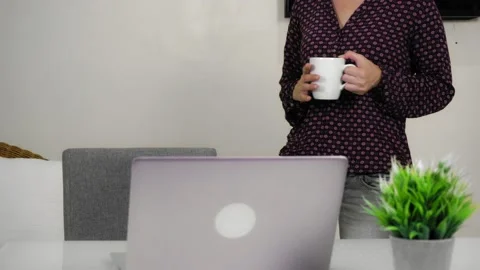 Young woman communicates by videoconference and walks around the room. Stock Footage 146885200