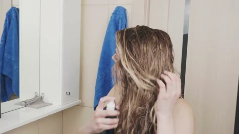 Young woman conditioning long wet hair after shower Stock Footage 178682353