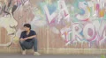 a young woman consoles a very sad man on the sidewalk - wall with grattiti HD Footage