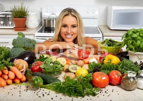 Young woman cooking in the kitchen. Stock Photos