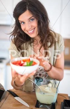 Young woman cooking a raw food dessert Stock Photos