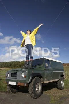 Young woman in countryside with suv Stock Photos