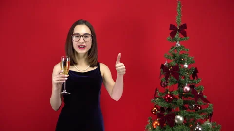 Young woman counts five seconds to the holiday with a glass of champagne near Stock Footage 143936341