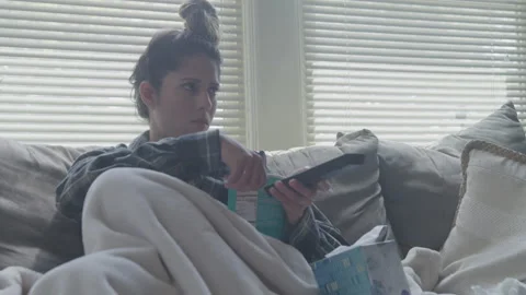 Young Woman Cries While Eating Ice Cream Watching TV On Couch Stock Footage 208716755
