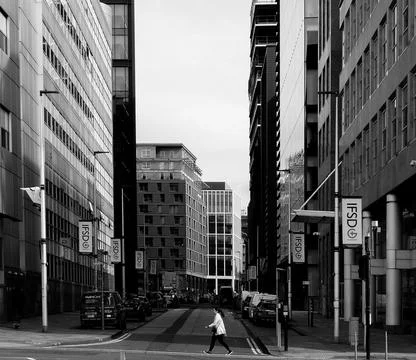 A young woman crossing an empty intersection in the city Stock Photos