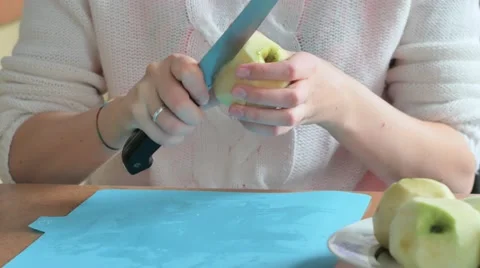 Young woman cutting an apple kitchen Stock Footage 68684853