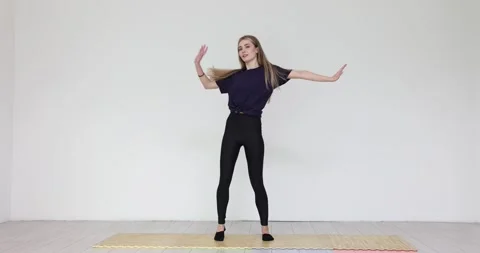 Young woman dancer engages in dancing routine in sports club Video stock 287274792