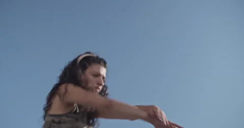 Young woman dancing against cloudless blue sky Video stock 209554142