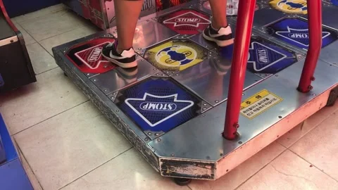 Young Woman Dancing on Arcade Rhythm Game Machine in Entertainment Center Stock Footage 335997906