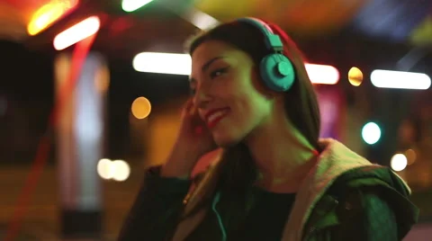 Young woman dancing to the rhythm of music with headphones Stock Footage 59556055