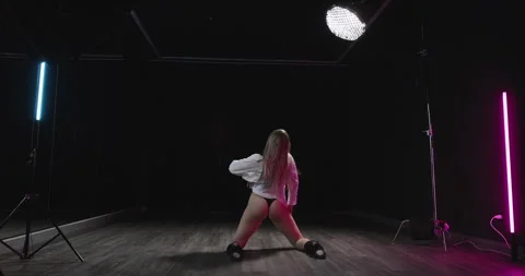 Young woman dancing sensually in a dance studio. Blonde dancer moving erotically Stock Footage 265466859