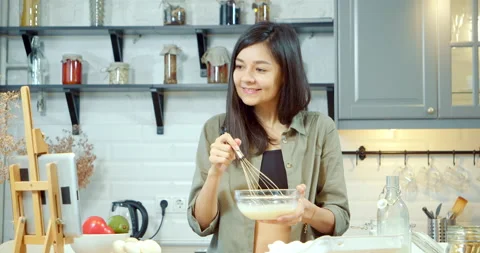 Young woman dancing while preparing breakfast listening to music using a tablet Stock Footage 132218663