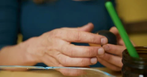 Young woman decorating easter egg with black paper Video stock 128534920