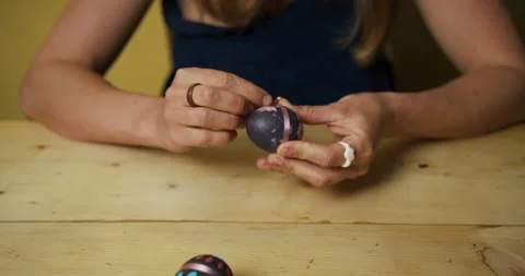 Young woman decorating easter eggs at table Stock Footage 130304730