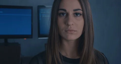 Young Woman Developer Programmer looking at camera at binary code background. Stock Footage 102669041