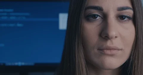Young Woman Developer Programmer looking at camera at binary code background Stock Footage 102845526