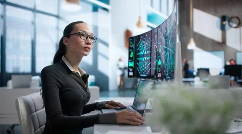 Young Woman Develops AI Models Using A Laptop In Office. Stock Photos