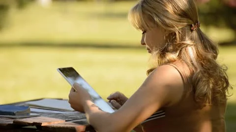 Young woman with digital tablet computer studying for college exam Stock Footage 12739417