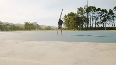 Young Woman Does Split Handstand Outside on Sunny Morning. Wide Shot Stockbeeldmateriaal 130394862