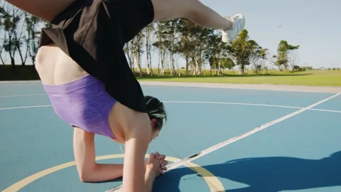 Young Woman Does Split Straddle Hollow Back Handstand on Sunny Morning Stock Footage 131209422