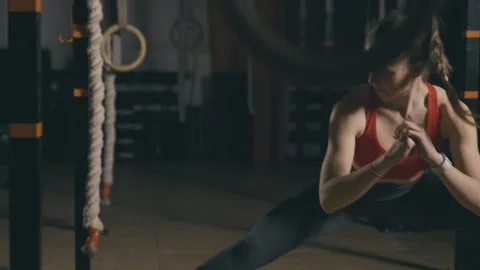 Young woman does stretching exercise Stock Footage 153089014
