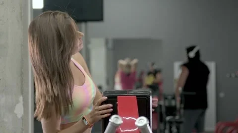 Young woman doing a back exercise in the machine gym Stock-Footage 160442924