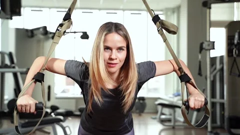 Young woman doing core abs crossfit training with straps in the gym. TRX. Stock Footage 101473239