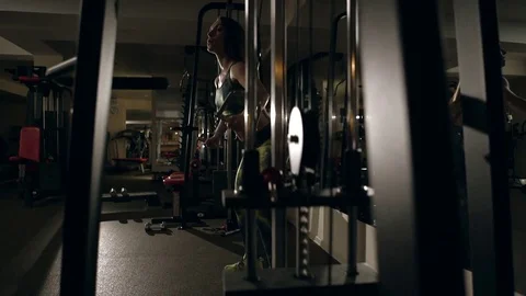 Young woman doing exercise for back on training machine Stock Footage 71479484