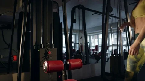 Young woman doing exercise for back on training machine Stock Footage 71479743