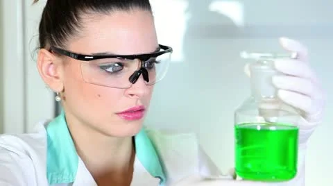 Young woman doing experiment Stock Footage 24672419