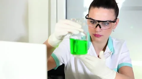 Young woman doing experiment Stock Footage 24672532