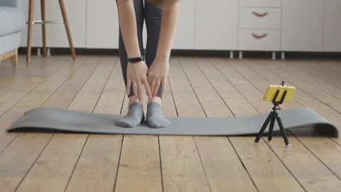 Young Woman Doing Final Stretch of her Online Fitness Training Stock Footage 152852941