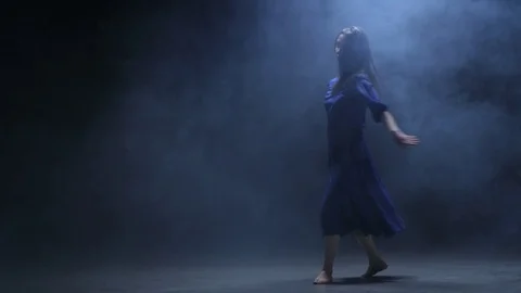 Young Woman Doing Jumps in Artificial Fog Stock Footage 72133689
