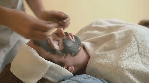 Young woman doing a mud face mask Video stock 69967780