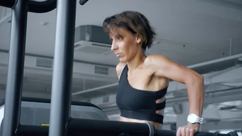 Young woman is doing push-ups on uneven bars in gym. Video stock 110787948