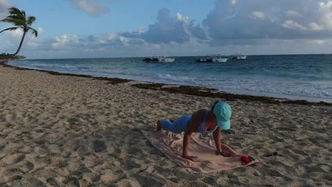 Young woman is doing push ups at the beach, sports during vacation Stock Footage 154802806