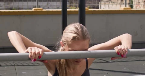 Young woman doing push ups on sport ground in city center Stockbeeldmateriaal 247555100